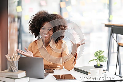 African American female employee write down on colorful sticky notes manage list, concentrated biracial woman work on Stock Photo