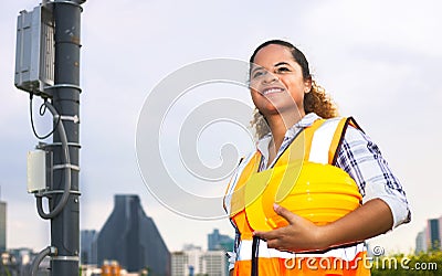 African American female engineer was checking the readiness of a communication tower Stock Photo