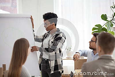 African American female give flipchart presentation for office w Stock Photo