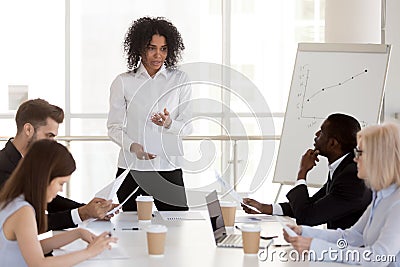 African-american female manager presenting report speaking at di Stock Photo