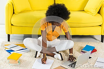 african american freelancer remote working on floor Stock Photo