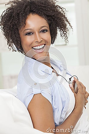 African American Girl Listening to MP3 Player Headphones Stock Photo