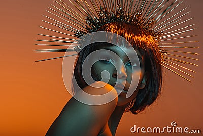 African american girl posing in headpiece with needles Stock Photo