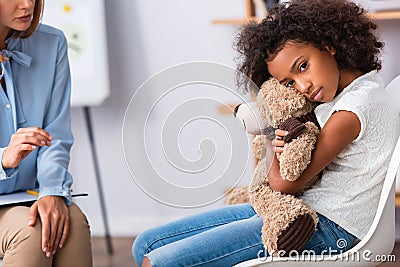 African american girl with soft bear Stock Photo