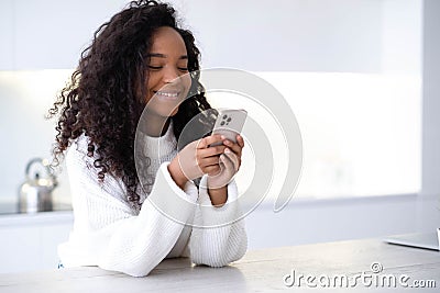 African American Girl using iPhone 12 smartphone pressing finger, reading social media internet, typing text or shopping Editorial Stock Photo
