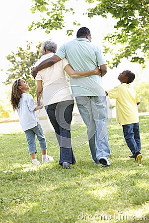 African American Grandparents With Grandchildren Walking In Park Stock Photo