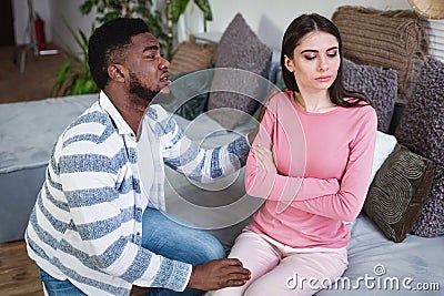 African american guy apologizes to european wife Stock Photo