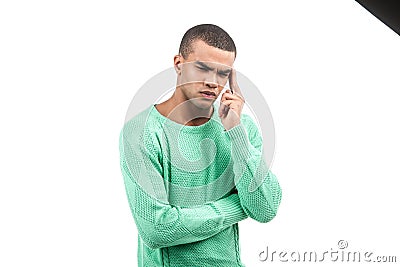 African american with head pain and green shirt. Stock Photo