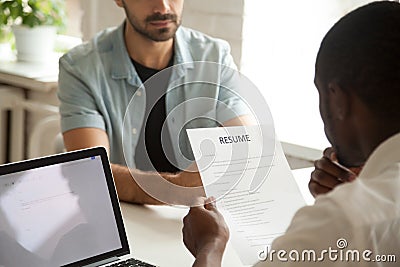 African-american hr manager holding reading applicants resume at Stock Photo