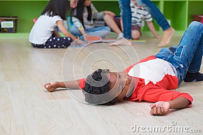 African American kid with loneliness emotion separate from group Stock Photo