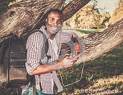 African american listens music in a park Stock Photo