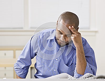 African American male looking at drawings. Stock Photo