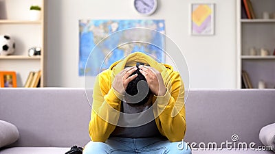 African-American male teenager losing video game, inadequate emotional reaction Stock Photo