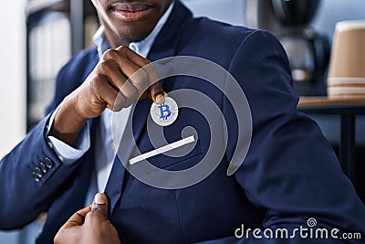 African american man business worker holding bitcoin at office Editorial Stock Photo