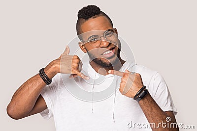 African American man in glasses show call back sign Stock Photo