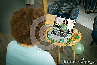 African american man having a video conference on laptop at a bar Stock Photo