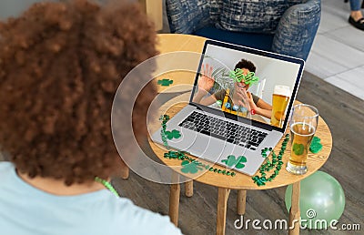 African american man having a video conference on laptop at a bar Stock Photo