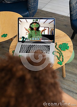 African american man having a video conference on laptop at a bar Stock Photo