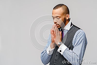 African american man holding hands in prayer hoping for better Stock Photo