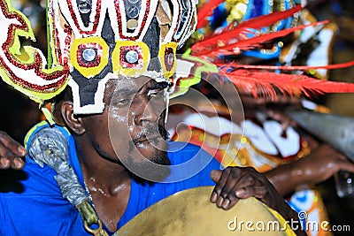 African-American man playing drum in celebration of the Junkanoo New Year's Day in Nassau Editorial Stock Photo