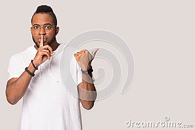 African American man show sale point at copy space aside Stock Photo