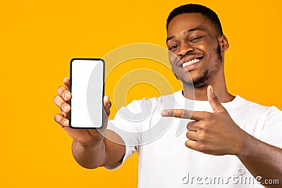 African American Man Showing Mobile Phone Screen, Yellow Background, Mockup Stock Photo