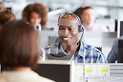 African American man working at a computer in a call centre Stock Photo