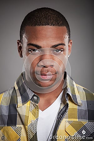 African American man yellow shirt looking Stock Photo