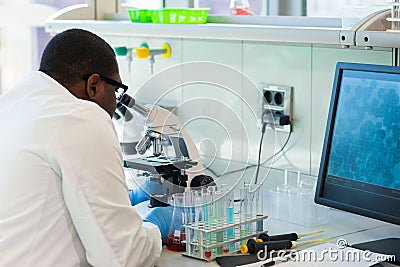 African-american medical doctor working in research lab. Science assistant making pharmaceutical experiments. Chemistry Stock Photo