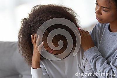 African American mom hug comforting sad teenage daughter Stock Photo