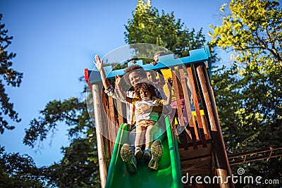 Mom playing with child on playground Stock Photo