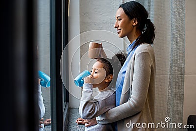 Mother and daughter drinking hot beverage Stock Photo