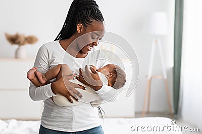 African American mother singing lullaby for infant to sleep Stock Photo