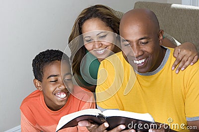 African American multicultural family reading The Bible. Stock Photo