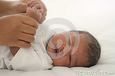 African american new born baby lying on white bed Stock Photo