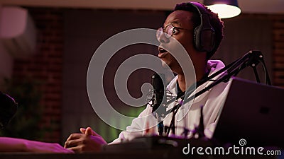 African american online radio presenter talking with influencer guest looking surprised Stock Photo