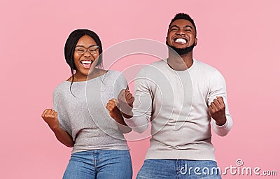African american partners rejoice success, clench fists and exclaim Stock Photo