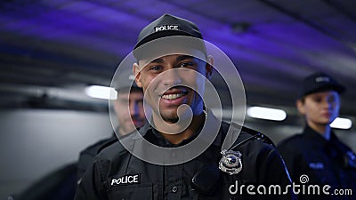 Policeman smiling at camera. Positive cop in uniform posing at camera Stock Photo