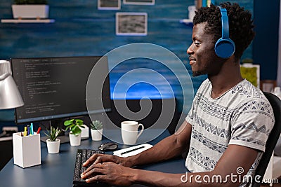 African american programmer with headphones writing program code Stock Photo