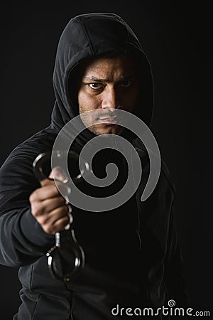 African american robber in zoodie and manacles isolated on black Stock Photo