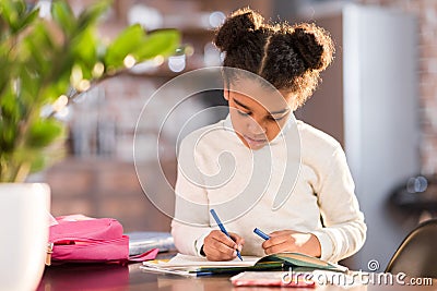 African american schoolgirl doing homework Stock Photo