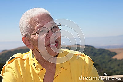 African American Senior Citizen Smiling Outdoors Stock Photo