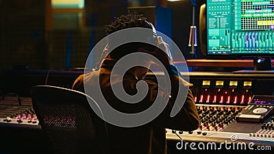 African american sound designer removing tonal imbalances and white noise Stock Photo