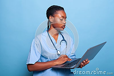 African american specialist assistant holding laptop computer typing disease expertise Stock Photo