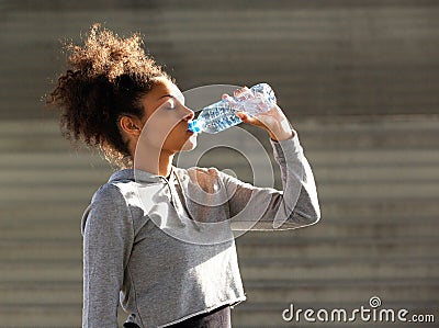 African american sports woman drinking from water bottle Stock Photo