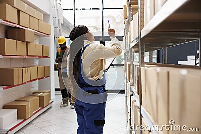 African american storehouse manager checking parcels maintenance Stock Photo