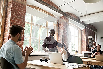 African american team leader performing victory dance in co-work Stock Photo