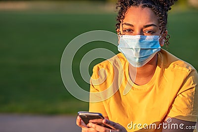 African American Teenager Girl Woman Wearing Coronavirus COVID-19 Face Mask Stock Photo