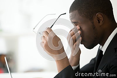African american tired businessman feeling eyes fatigue taking o Stock Photo