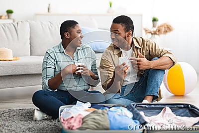 African American Travelers Using Smartphone With Application For Tourists Indoors Stock Photo